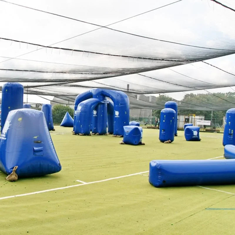 Blue inflatable bunkers arranged on a speedball field