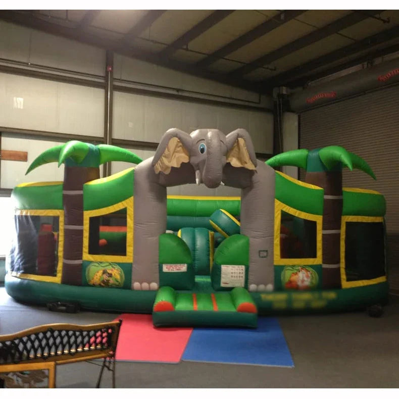 Pista de obstáculos inflable con tobogán y casa de rebote temática de selva