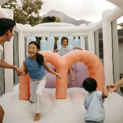 Pastel Inflatable Bounce House with Obstacles